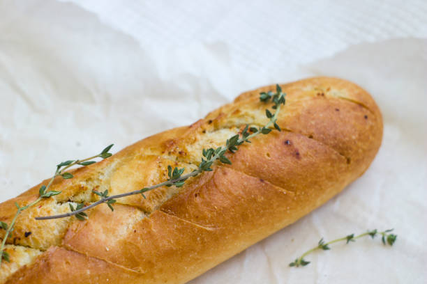 istock French baguettes with thyme on kraft paper. 1136415287