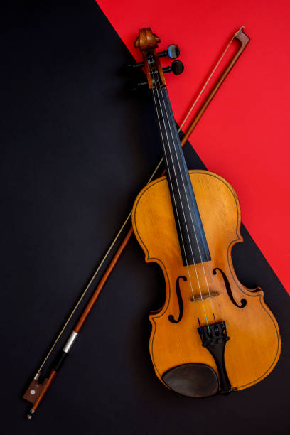 istock Violin and bow on a red and black background 1136416258