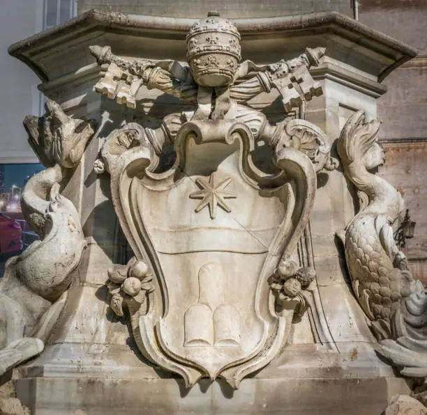 Photo of Pope Clement XI coat of arms in the Pantheon Fountain. Rome, Italy.