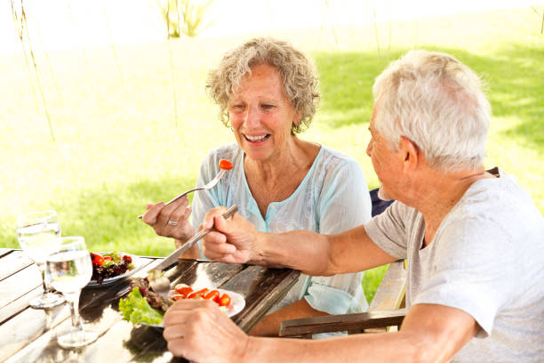 istock Senior couple enjoying meal at table in resort 1136419625
