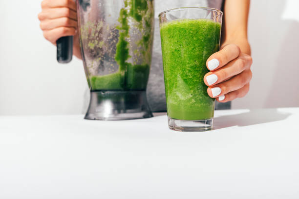 istock Woman's hands with white manicure holding blender 1136419688