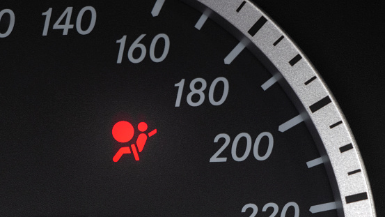 Red lighting air bag control symbol in car