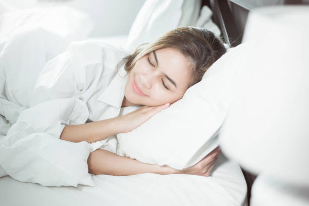 istock Beautiful woman sleeping on bed 1136421191