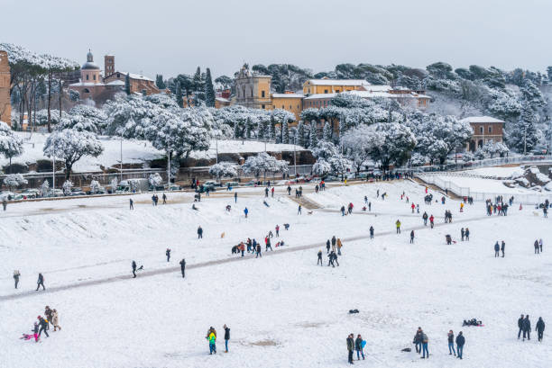 Snow in Rome in February 2018, panoramic view of the Circo Massimo with people playing. Snow in Rome in February 2018, panoramic view of the Circo Massimo with people playing. circo massimo stock pictures, royalty-free photos & images