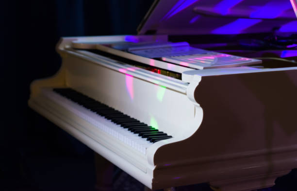 istock White concert piano illuminated by colored spotlights. 1136422218