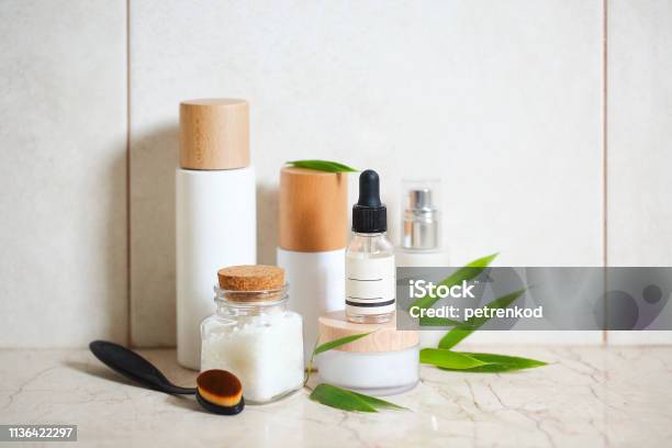 Face Cream Serum Lotion Moisturizer And Sea Salt Among Bamboo Leaves Stock Photo - Download Image Now
