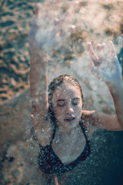 istock Exotic Female Enjoying Beach Sanding Shower 1136422401