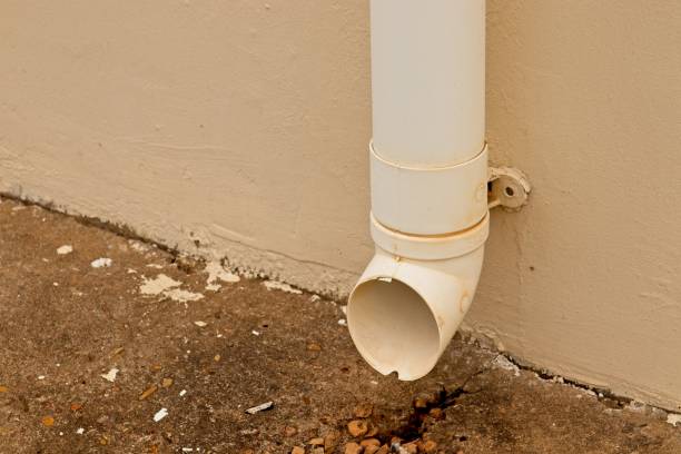 istock An old plastic gutter drainage pipe mounted to the wall of a house. 1136422671