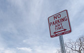 No parking anytime sign against the sky with plenty of copy space.