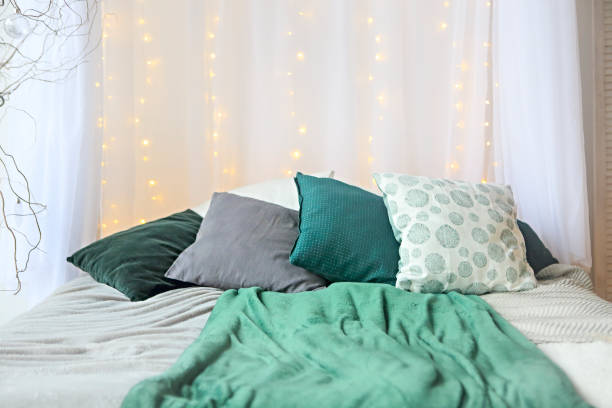 White and green bedroom with lights on the wall