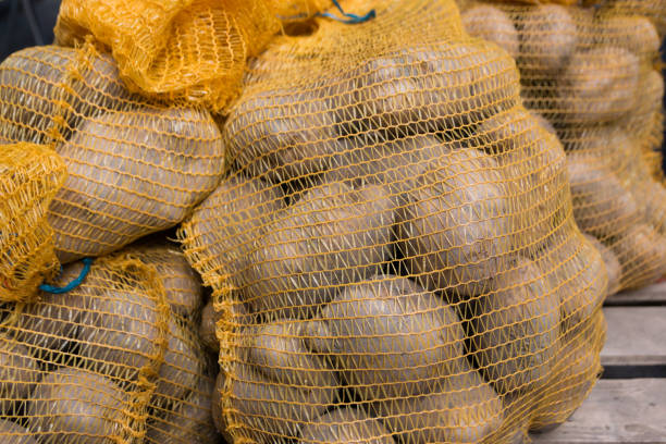 istock rustic bag of potatoes on wood background 1136424089
