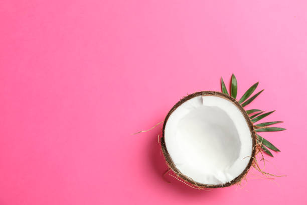 istock Half tropical coconut on color background, space for text 1136424127
