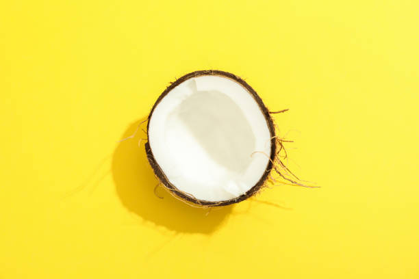 istock Half tropical coconut on color background, space for text 1136424163