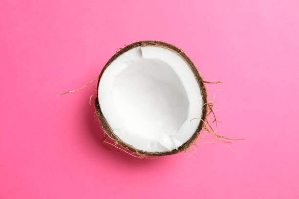 istock Half tropical coconut on color background, space for text 1136424180
