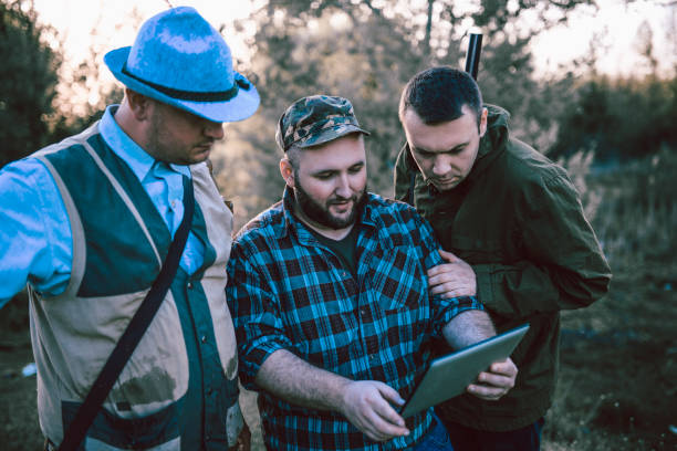 istock Hunters Looking At A Map On Digital Tablet For Directions 1136425342