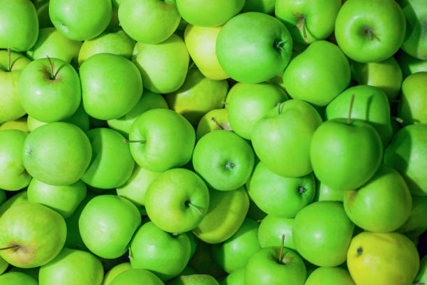 istock bunch of bright juicy green apples, background, texture 1136426025