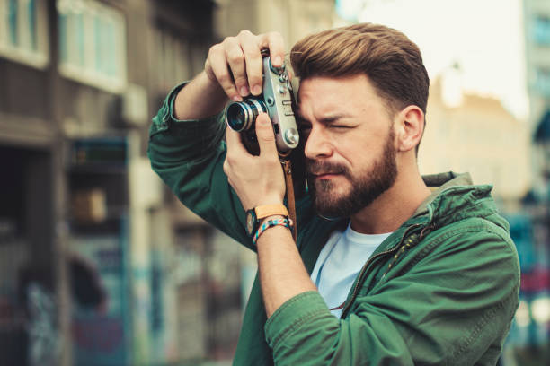 istock Young male tourist taking photos while traveling 1136427519