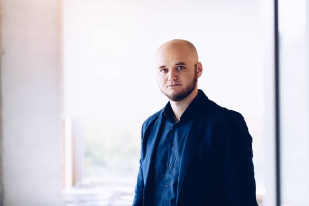 istock Young businessman standing in office. 1136429385