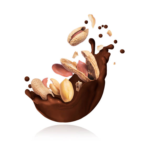 istock Splash of melted chocolate with crushed peanuts closeup on white background 1136429505