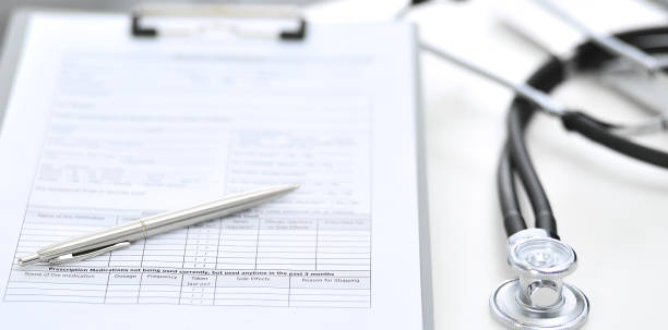 istock Stethoscope, clipboard with medical form lying on hospital reception desk with laptop computer. Medical tools at doctor working table.Medicine and health care concept 1136432981