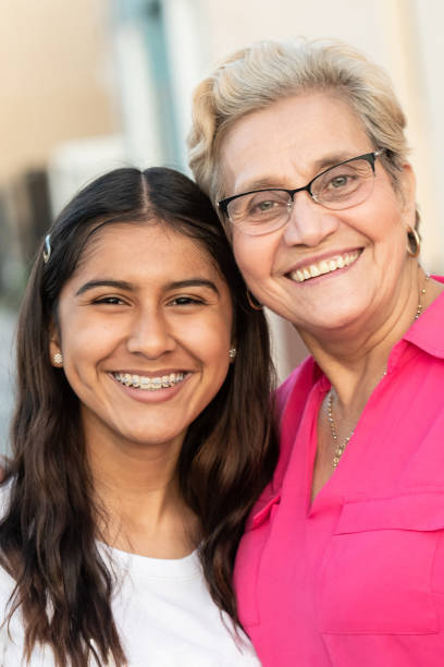 istock thirteen Years old hispanic girl posing with her grandmother 1136433251