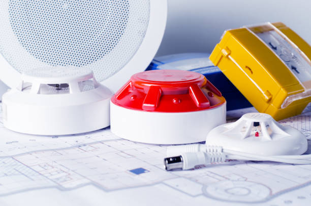 istock Fire security equipment and blueprint on a table. Good for security servise engeniering company site 1136435988