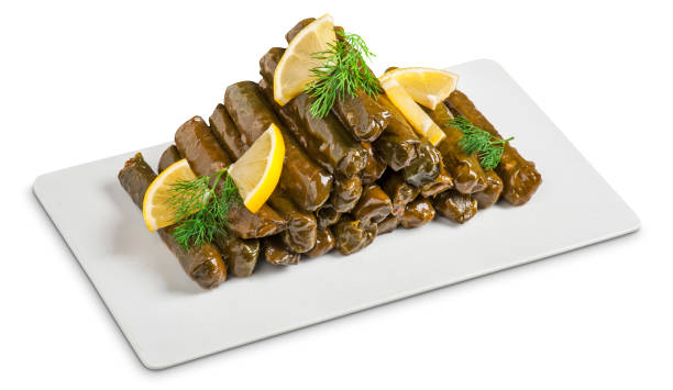 a pile of dolmades with lemon on a white background in turkey - dolmades imagens e fotografias de stock