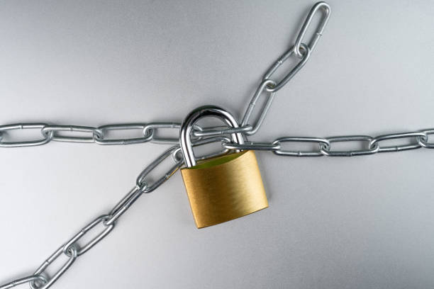 istock Padlock with chain on steel grey background. 1136436017