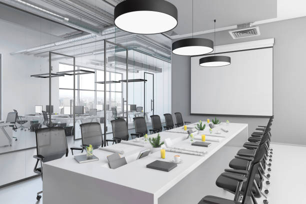 istock Contemporary conference room interior with large blank projection screen 1136436754