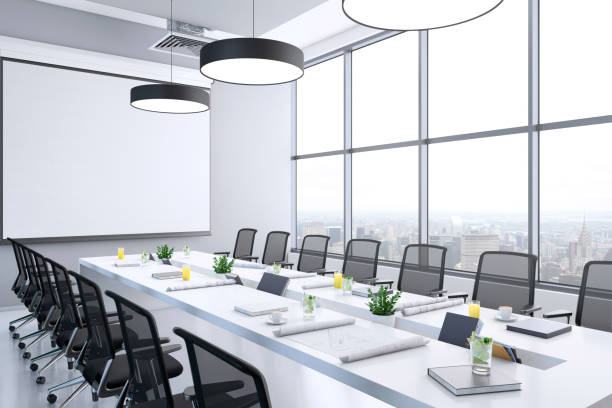 istock Contemporary conference room interior with large blank projection screen 1136436755