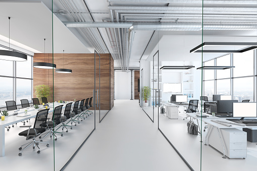 Modern office interior, many work stations with desktop computer and large LCD screen. White floor and minimalist materials. no people, template copy space render