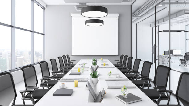 istock Contemporary conference room interior with large blank projection screen 1136436805