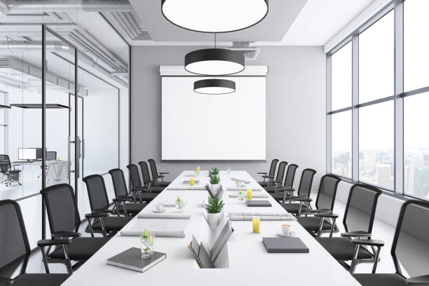 istock Contemporary conference room interior with large blank projection screen 1136436810