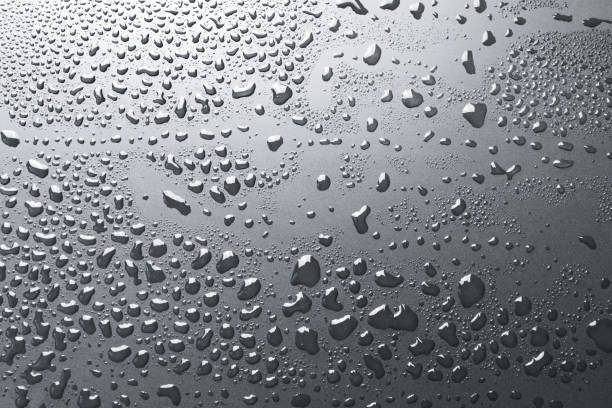 istock Shiny water drops on silvery metal surface, background 1136441703