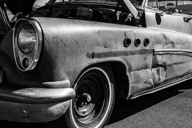An old Buick with damaged fender.