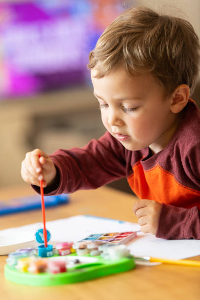 istock Three years old child painting with watercolors 1136443060