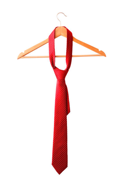 Red male tie hanging on the wooden rack. Isolated on white background.