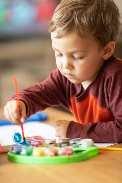 istock Three years old child painting with watercolors 1136443549