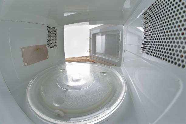istock Empty microwave for preparing dishes in the home kitchen. Device for heating dishes with the use of myocual waves. Light background. 1136444319