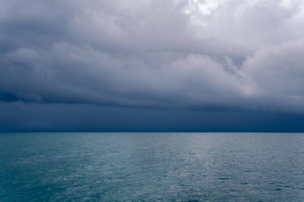 A tropical typhoon moves violently over the Andaman Sea, Krabi, Thailand.  This extreme weather event is also known as tornado, cyclone or hurricane, are unfortunately becoming more common around the world, due to Global Warming and Climate Change.  These weather patterns are violent and dangerous, often claiming numerous lives in the areas which they occur.