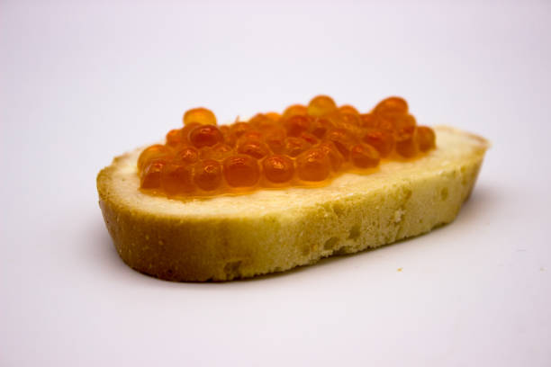 istock Red caviar on sandwiches on the white background 1136445537