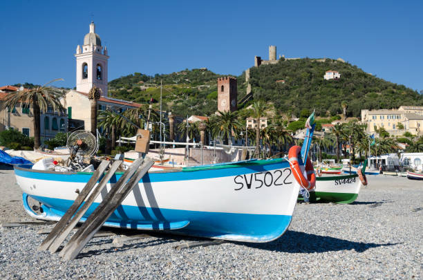 Noli, Liguria, 23rd October 2018. A view of the beautiful Ligurian seaside town from Fisherman's beach. Working fishing boats are drawn up onto the beach when not in use.