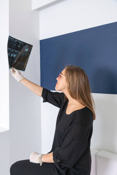 istock female doctor looking at an x-ray 1136447079
