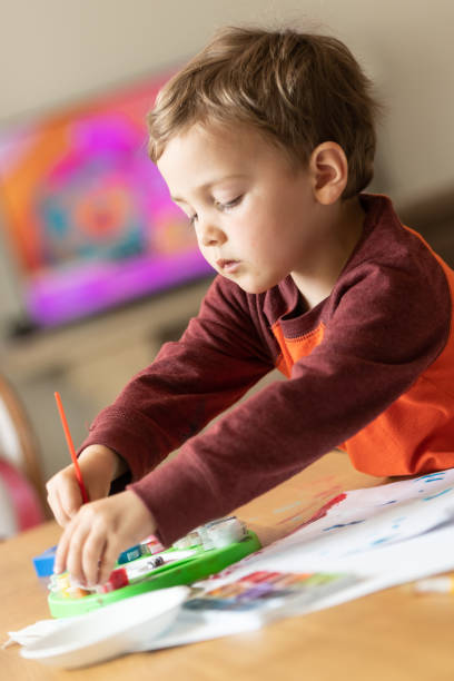 istock Three years old child painting with watercolors 1136449181