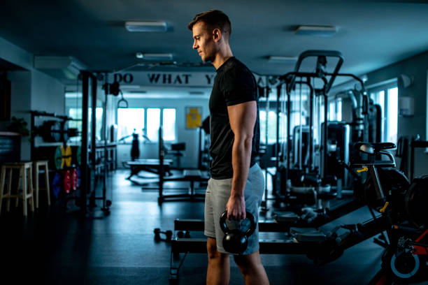 istock Side view of a Young man Cross Training With Kettle Bell 1136449246