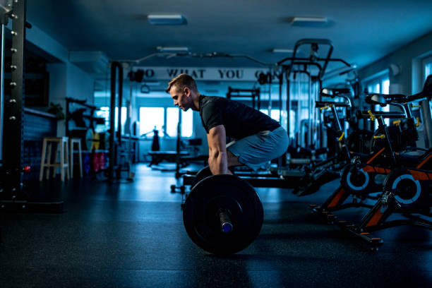 istock Young Man in the Gym Executing a Deadlift Training - initial position 1136449262