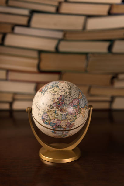 istock globe and many books on a wooden table 1136449493