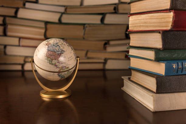 istock globe and many books on a wooden table 1136449495