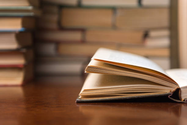 istock open book on the table against the background of books 1136449510