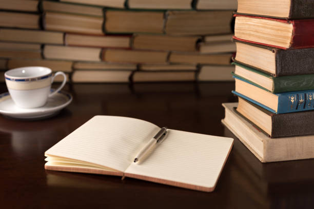 istock open notebook and cup on the background of books 1136449518